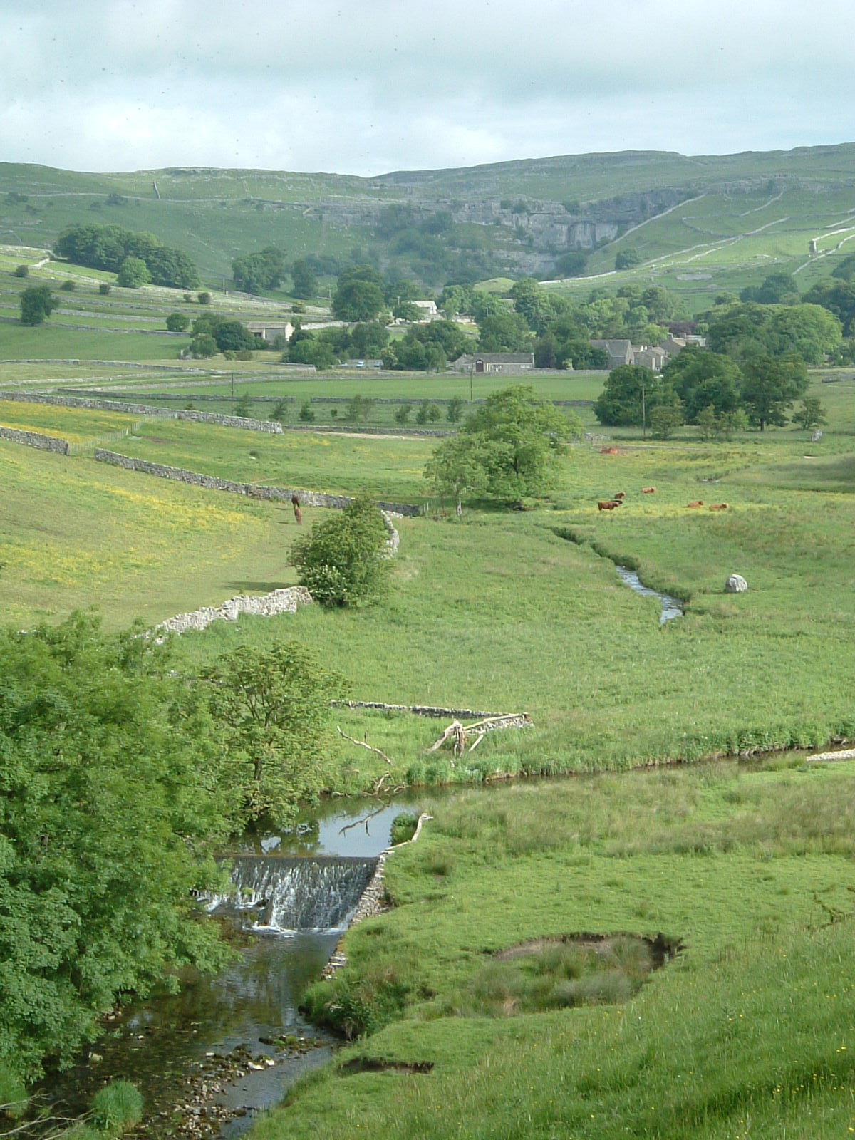 The village of Malham with Malham Cove in the distance