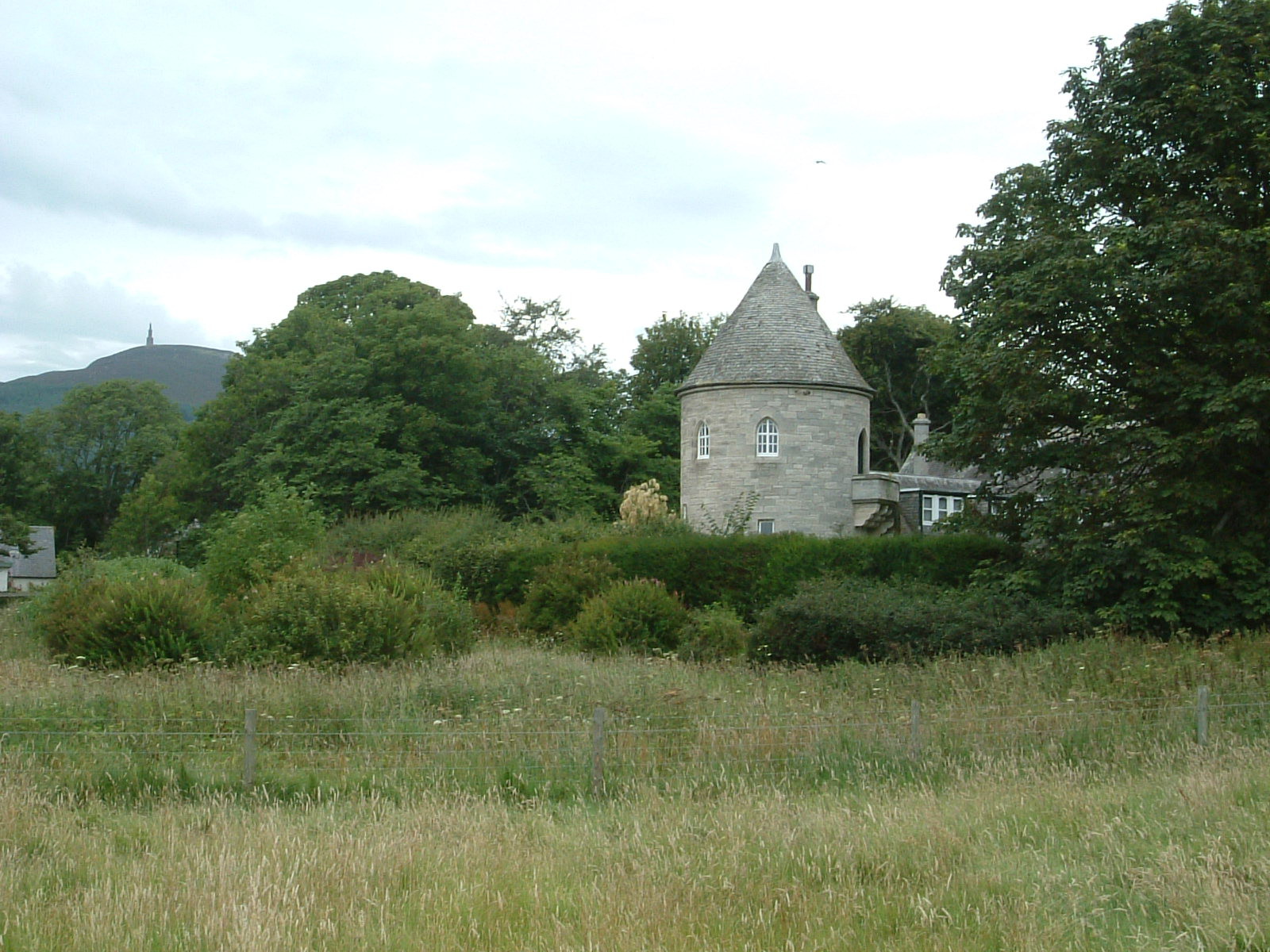 Tower Lodge with Ben Bhraggie in the background, topped by a large statue of the first Duke of Sutherland
