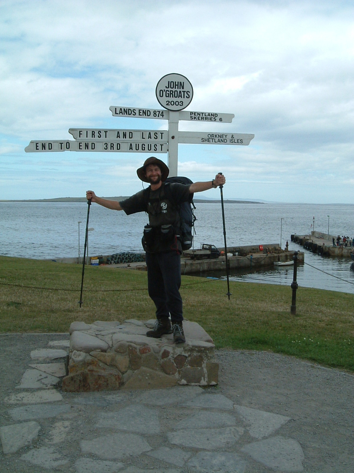 Mark posing by the signpost at John o'Groats