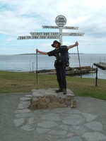 Mark posing by the signpost at John o'Groats