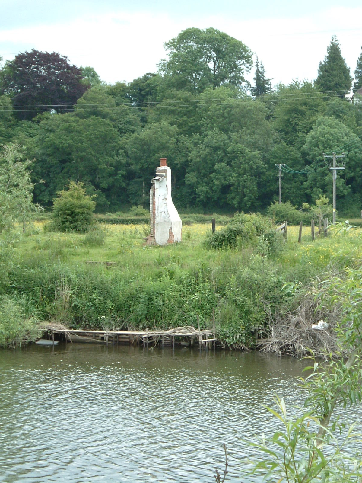 A chimney in the middle of a field