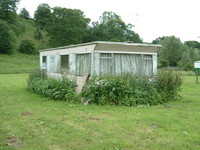 A not-so-posh static caravan gently mouldering by the River Severn